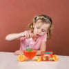 Young Girl Eating Simply desserts Orange Jel
