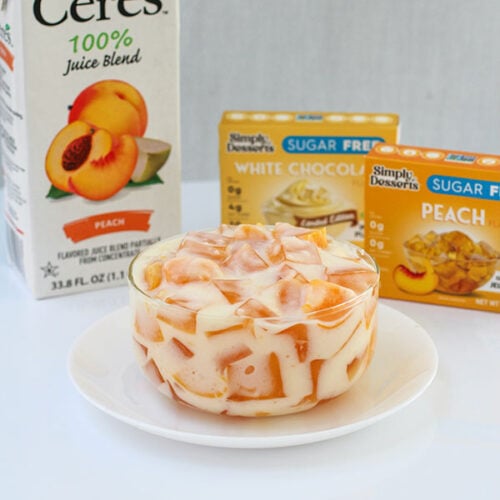 Peaches and cream jel salad surrounded by Ceres Peach Juice and Simply Desserts product boxes