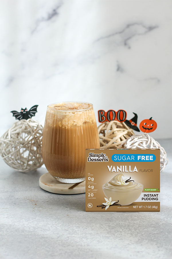 The ultimate fall treat—Pumpkin Spice Latte made with Simply Desserts Sugar Free Vanilla Pudding, styled with festive Halloween decor