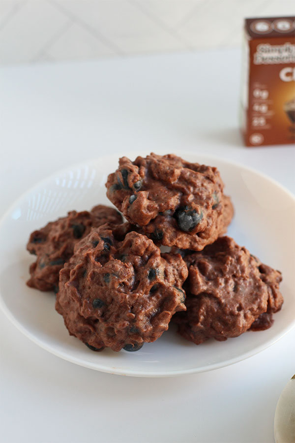 Close-up of frozen blueberry clusters coated in Simply Desserts Chocolate Pudding, served on a white plate
