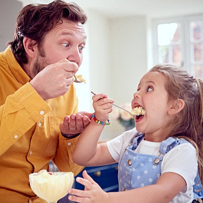 Dad and daughter enjoying White Chocolate Pudding