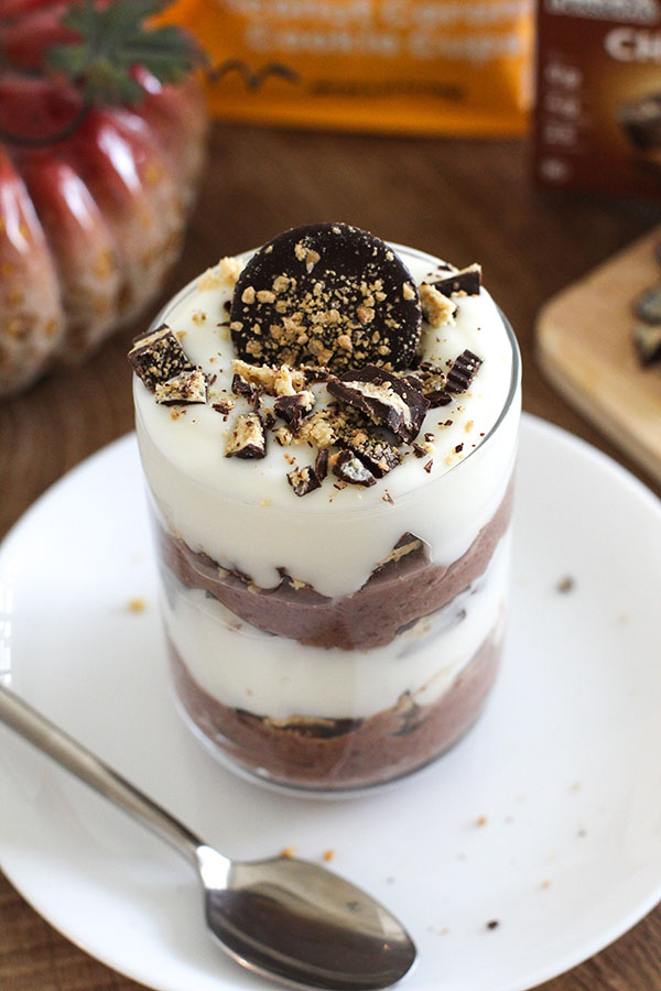 Close-up of a layered parfait topped with crushed Chocxo chocolate caramel cookie cups