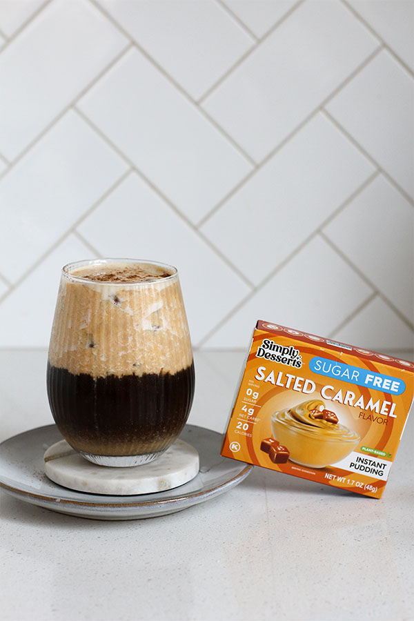 Pumpkin salted caramel pudding latte with Simply Desserts Salted Caramel Pudding Mix box beside the glass