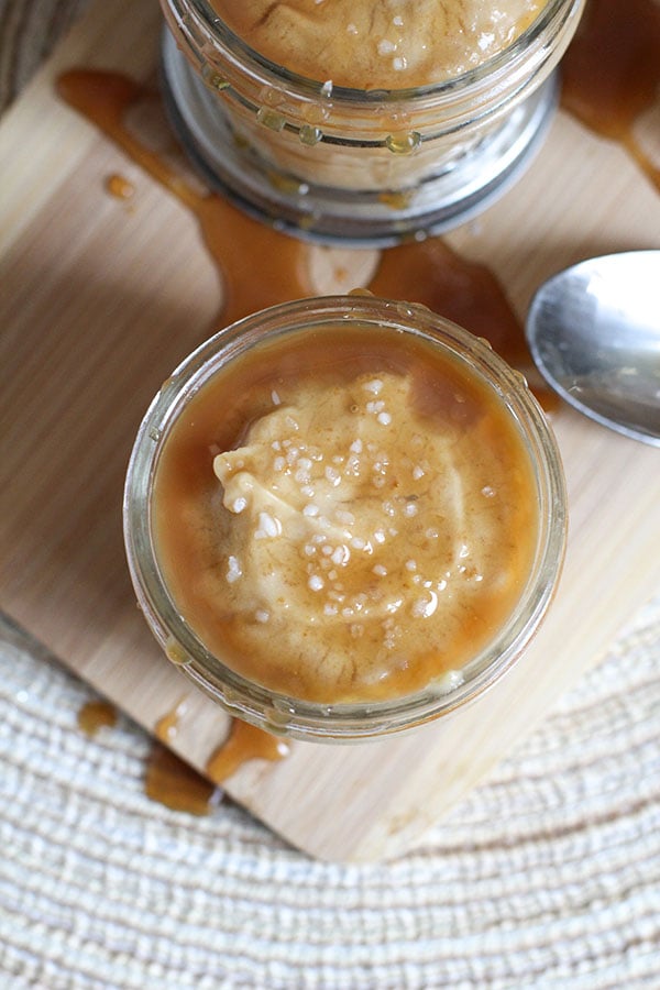 Close up of caramel pudding cup with caramel drizzle and sea salt