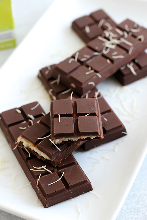 Flat lay of homemade chocolate bars filled with pistachio pudding and kataifi topping