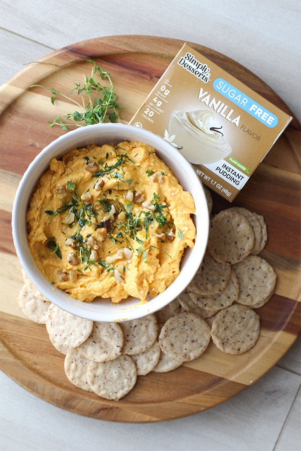Top view of savory pumpkin dip served with crackers and Simply Desserts Vanilla Pudding box