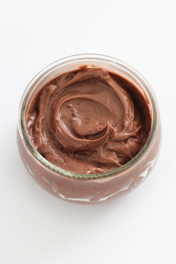 A close-up of a glass jar filled with thick, creamy Simply Desserts Sugar-Free Chocolate Pudding