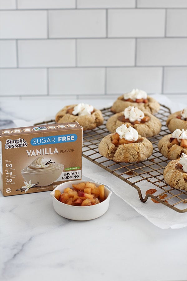 Simply Desserts Vanilla Pudding box with freshly baked apple pie cookies on a wire rack