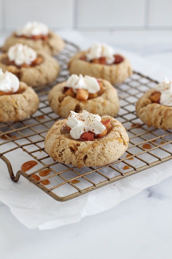 Close-up of sugar-free apple pie cookies topped with whipped cream and cinnamon