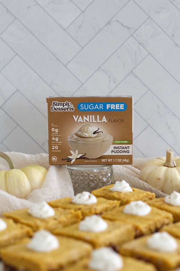 Simply Desserts Sugar-Free Vanilla Pudding box displayed behind pumpkin pie bars and white pumpkins