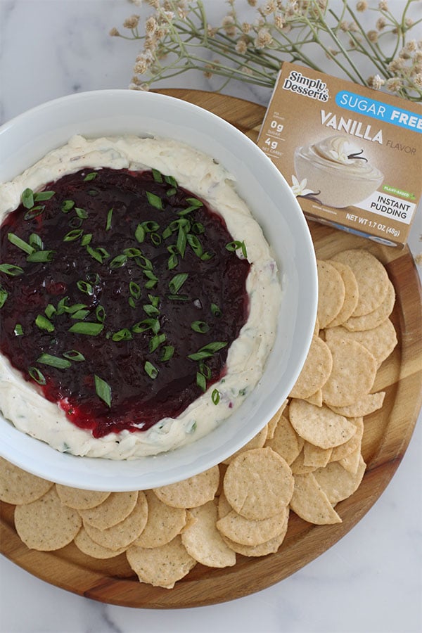 Overhead view of creamy cranberry jalapeño dip served with almond crackers with simply desserts vanilla pudding